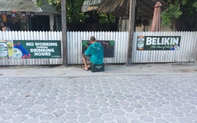 Karaoke in Belize Wade paints his sign
